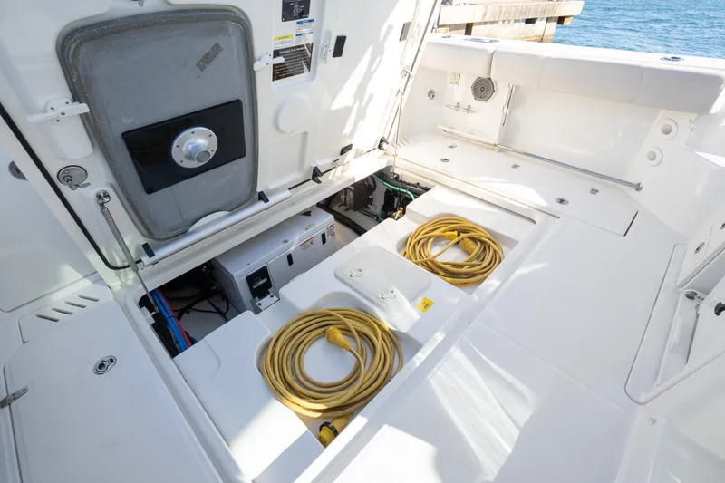  Yacht Photos Pics 2015 Boston Whaler 345 Conquest boat deck with storage compartments and coiled cables.