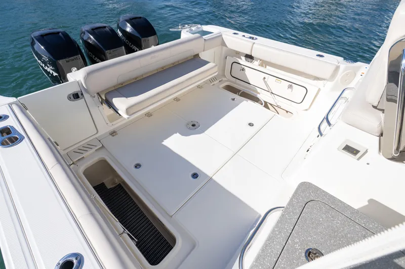  Yacht Photos Pics 2015 Boston Whaler 345 Conquest boat deck with seating and storage, featuring triple outboard engines.