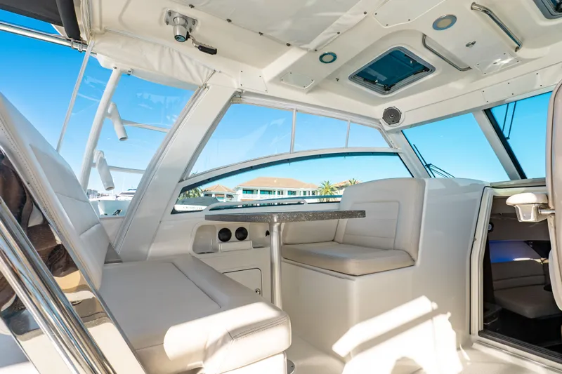  Yacht Photos Pics Interior of 2015 Boston Whaler 345 Conquest boat, featuring seating and table.