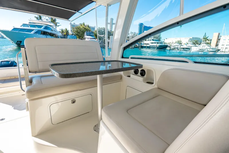  Yacht Photos Pics 2015 Boston Whaler 345 Conquest interior with seating and table, docked near yachts.