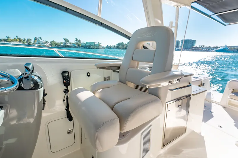  Yacht Photos Pics Captain's seat on 2015 Boston Whaler 345 Conquest, overlooking sunny ocean view.