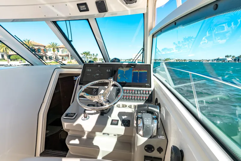  Yacht Photos Pics Helm of 2015 Boston Whaler 345 Conquest with navigation screens and ocean view.