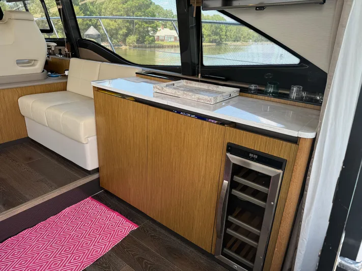 Graceful Yacht Photos Pics Interior of 2017 Sea Ray Sundancer 460 yacht with seating and mini fridge.