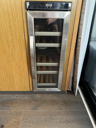 Graceful Yacht Photos Pics Wine cooler in 2017 Sea Ray Sundancer 460 yacht interior, featuring wooden flooring.