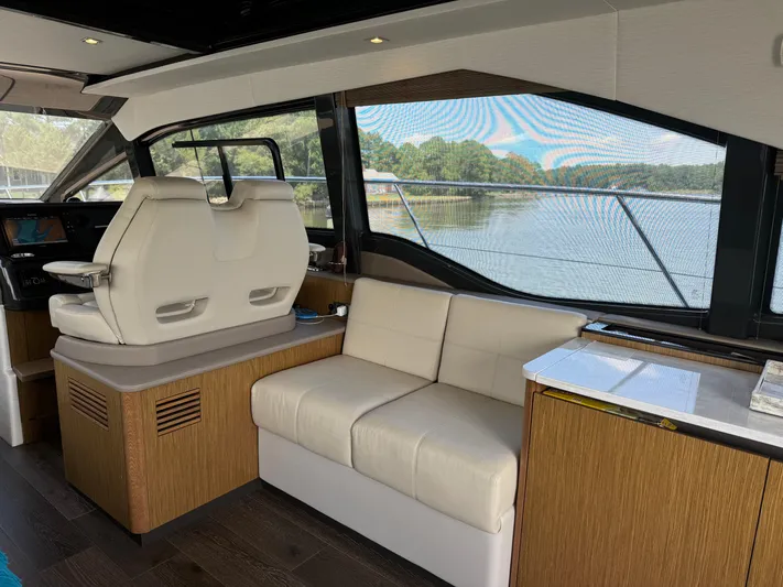Graceful Yacht Photos Pics Interior of 2017 Sea Ray Sundancer 460 yacht with modern seating and scenic window view.