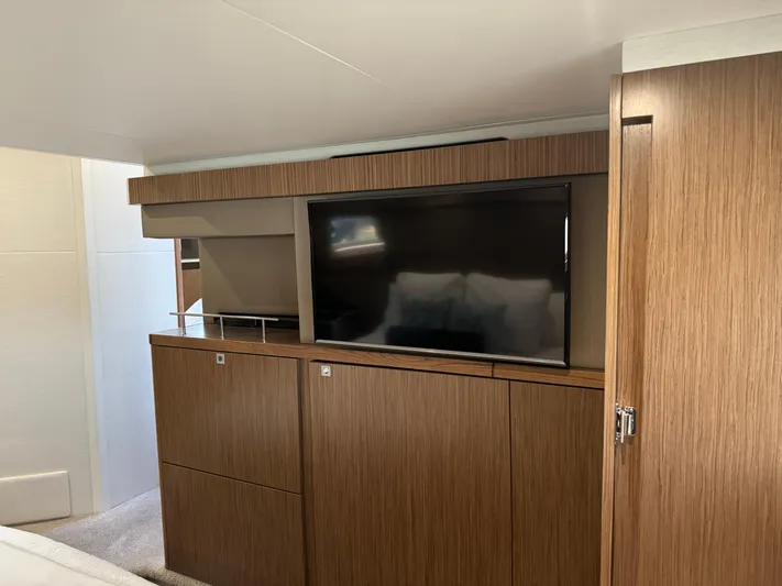 Graceful Yacht Photos Pics Interior of 2017 Sea Ray Sundancer 460 with wooden cabinetry and built-in TV.