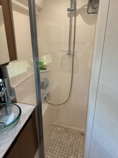 Graceful Yacht Photos Pics Shower area in 2017 Sea Ray Sundancer 460 yacht, featuring modern fixtures and glass door.