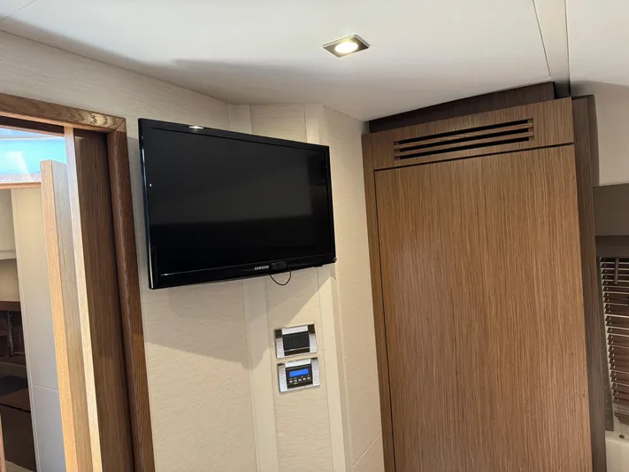 Graceful Yacht Photos Pics Interior of 2017 Sea Ray Sundancer 460 yacht with wall-mounted TV and wooden cabinetry.