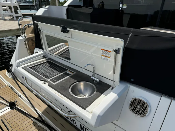 Graceful Yacht Photos Pics Outdoor kitchenette on 2017 Sea Ray Sundancer 460 yacht with sink and grill.
