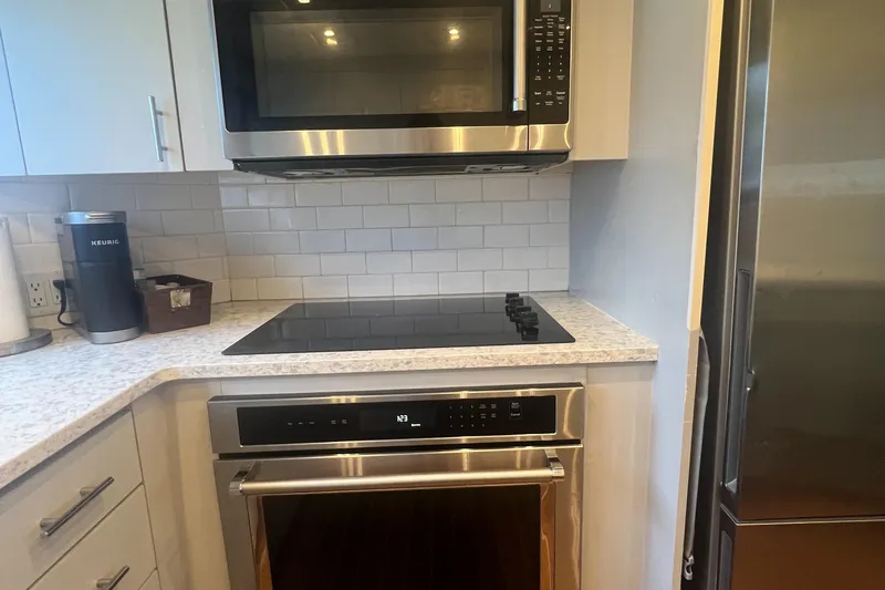 Havana Moon Yacht Photos Pics Modern kitchen with stainless steel appliances and white subway tile backsplash.