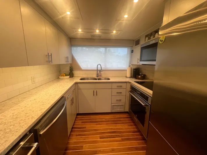 Havana Moon Yacht Photos Pics Modern kitchen interior on 1990 Hatteras 70 Cockpit Motor Yacht with stainless steel appliances.