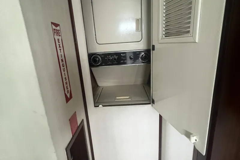 Havana Moon Yacht Photos Pics 1990 Hatteras 70 Cockpit Motor Yacht laundry area with stacked washer and dryer.