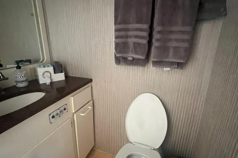 Havana Moon Yacht Photos Pics Bathroom interior of 1990 Hatteras 70 Cockpit Motor Yacht with towels and sink.