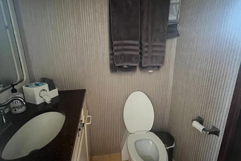 Havana Moon Yacht Photos Pics Bathroom interior of 1990 Hatteras 70 Cockpit Motor Yacht with modern amenities.