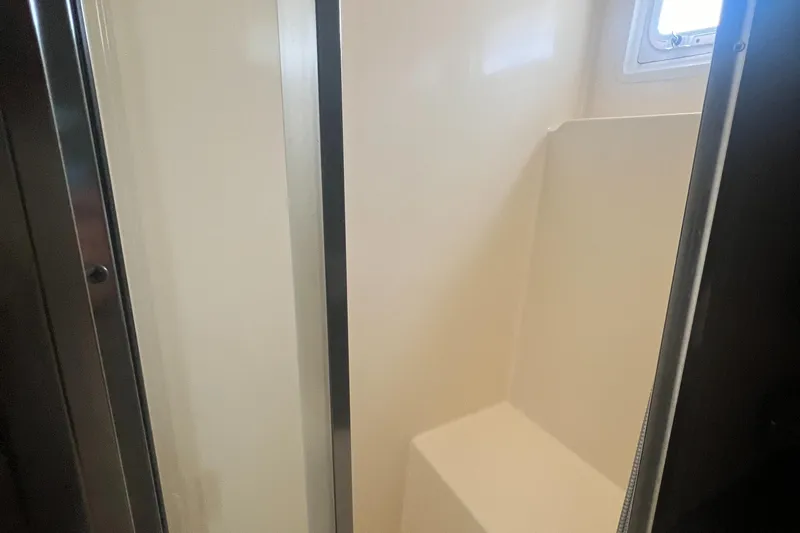 Havana Moon Yacht Photos Pics Shower area in 1990 Hatteras 70 Cockpit Motor Yacht, featuring sleek design and compact space.