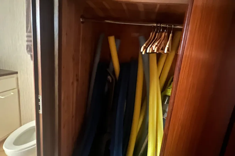 Havana Moon Yacht Photos Pics Closet with pool noodles and hangers on a 1990 Hatteras 70 Cockpit Motor Yacht.