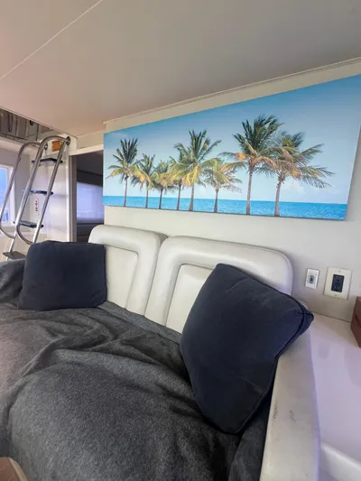 Havana Moon Yacht Photos Pics Interior of 1990 Hatteras 70 Yacht with palm tree artwork and cozy seating.
