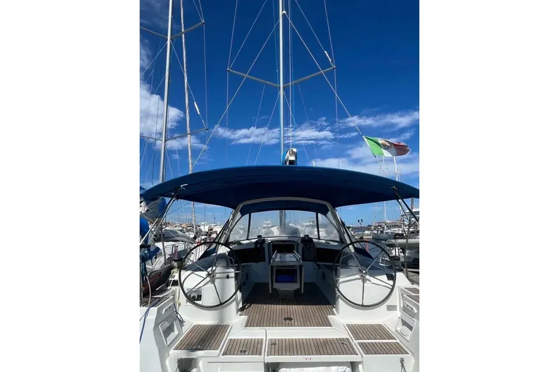  Yacht Photos Pics 2018 Beneteau Oceanis 48 sailboat with dual steering wheels in a marina.