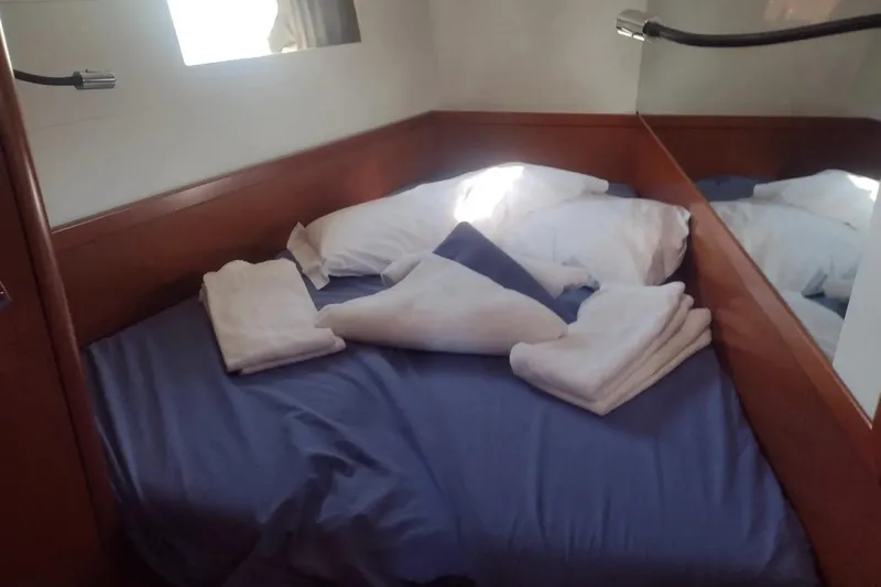 Yacht Photos Pics Cozy cabin bed with blue sheets in 2018 Beneteau Oceanis 48 yacht.