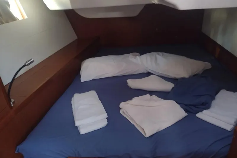  Yacht Photos Pics Cozy cabin bed with blue sheets in 2018 Beneteau Oceanis 48 yacht.