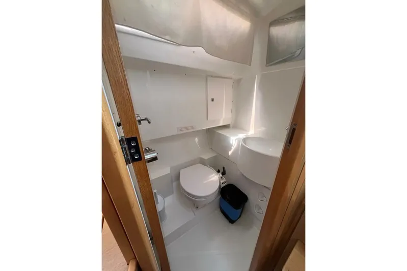  Yacht Photos Pics Bathroom interior of 2018 Beneteau Oceanis 48 yacht, featuring toilet and sink.