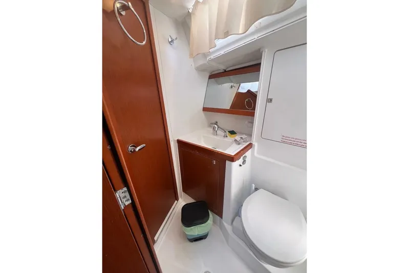  Yacht Photos Pics Bathroom interior of 2018 Beneteau Oceanis 48 yacht, featuring sink and toilet.