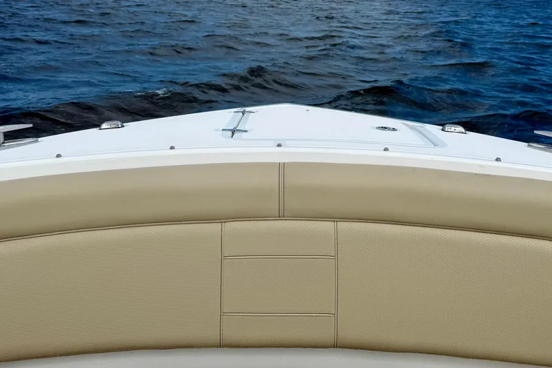  Yacht Photos Pics 2019 Pursuit S 328 Sport boat bow with beige seating, on open water.