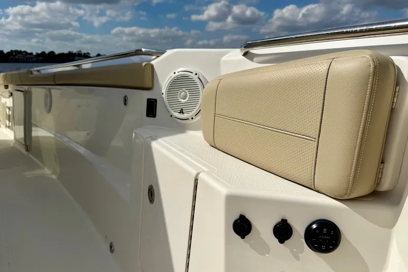  Yacht Photos Pics 2019 Pursuit S 328 Sport boat interior with beige seating and audio controls.