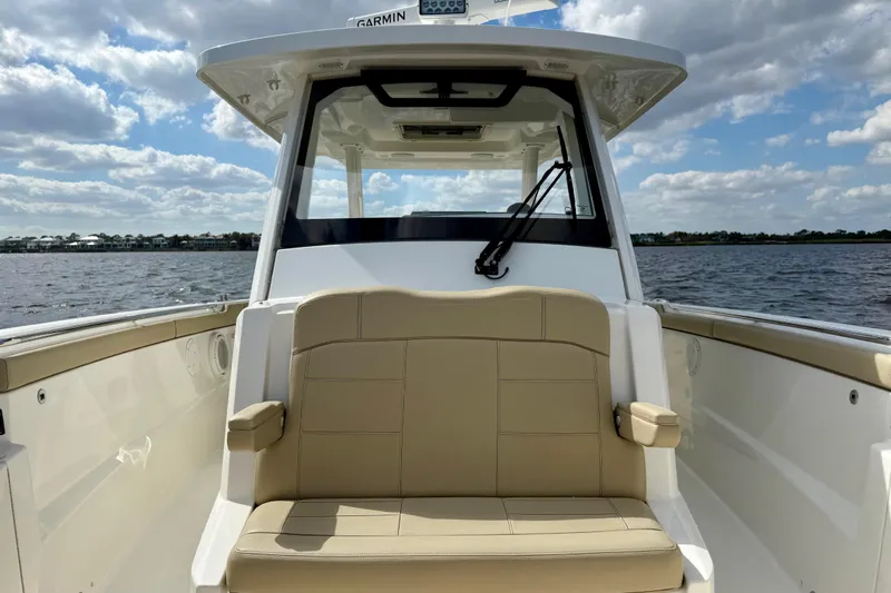  Yacht Photos Pics 2019 Pursuit S 328 Sport boat interior with beige seating, on a sunny day.