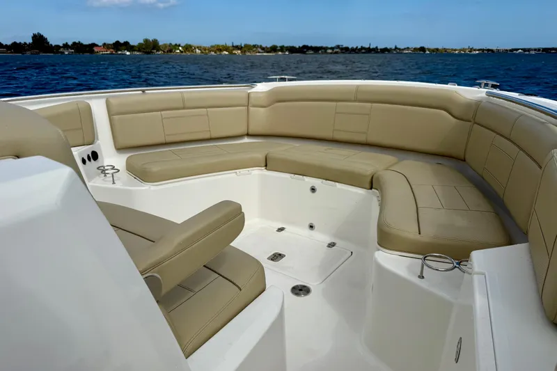  Yacht Photos Pics 2019 Pursuit S 328 Sport boat with spacious tan seating and ocean view.