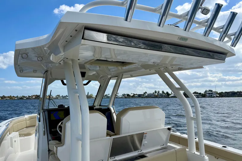  Yacht Photos Pics 2019 Pursuit S 328 Sport boat on water, featuring helm and seating area.