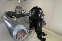 2020 Grand G420 boat with Mercury 60 outboard motor in a showroom.