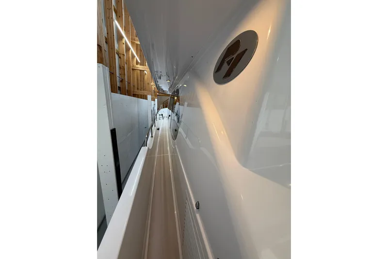  Yacht Photos Pics Sleek custom motor yacht side view, 2000 model, in a wooden dock setting.