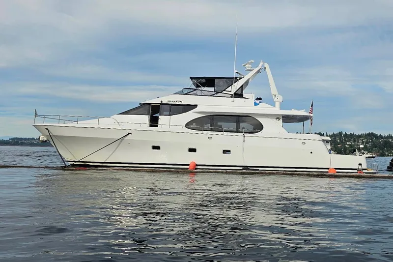  Yacht Photos Pics Custom 2000 motor yacht on calm water with scenic background.