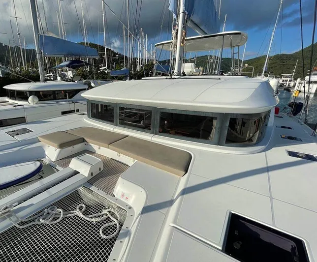 Kowi Kai Yacht Photos Pics Lagoon 50 catamaran, 2020 model, docked in a marina with scenic mountain backdrop.