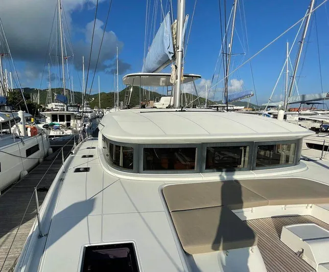 Kowi Kai Yacht Photos Pics 2020 Lagoon 50 catamaran docked at marina under clear blue sky.