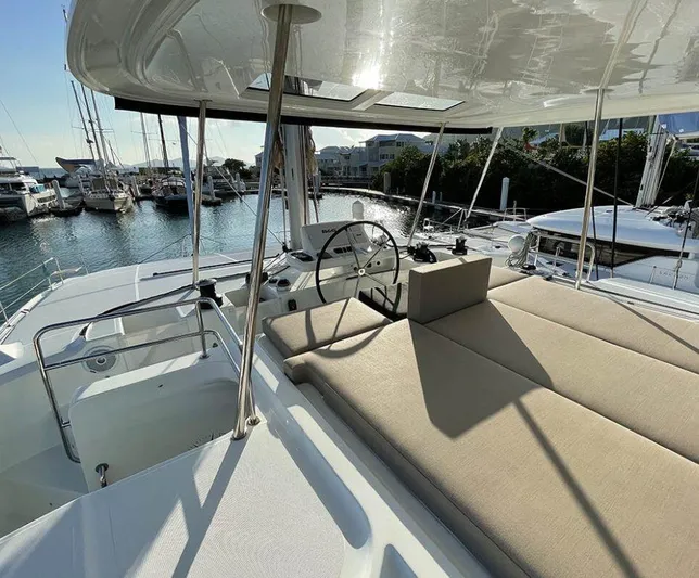 Kowi Kai Yacht Photos Pics 2020 Lagoon 50 catamaran with spacious deck and helm, docked in a marina.