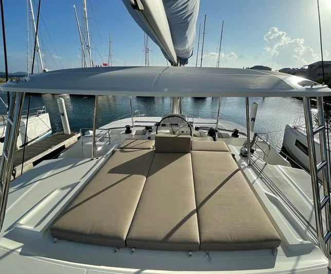 Kowi Kai Yacht Photos Pics Lagoon 50 catamaran 2020 model with spacious deck and sunbathing area in marina.
