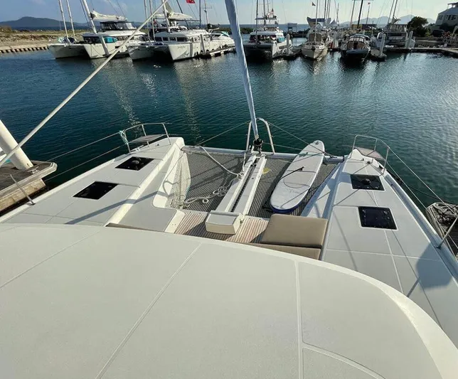 Kowi Kai Yacht Photos Pics 2020 Lagoon 50 catamaran docked at marina with paddleboards on deck.