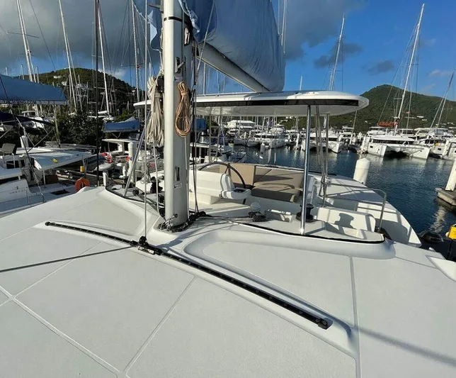 Kowi Kai Yacht Photos Pics 2020 Lagoon 50 catamaran docked in a marina, featuring a spacious deck and sail.