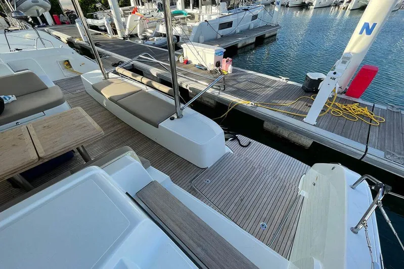 Kowi Kai Yacht Photos Pics Lagoon 50 catamaran docked at marina, showcasing spacious deck and seating area, 2020 model.
