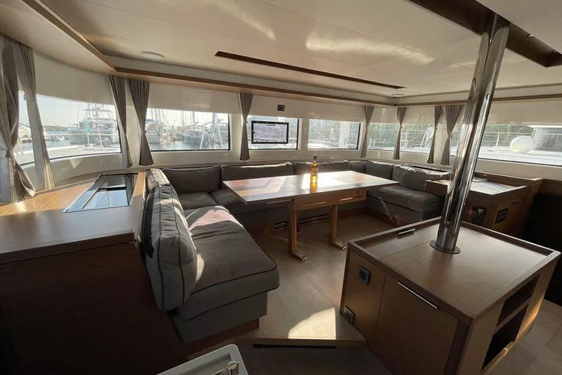 Kowi Kai Yacht Photos Pics Luxurious interior of 2020 Lagoon 50 catamaran with spacious seating and panoramic windows.