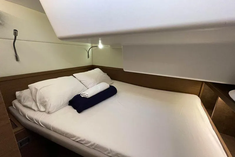Kowi Kai Yacht Photos Pics Cozy cabin interior of 2020 Lagoon 50 yacht with neatly arranged bedding.