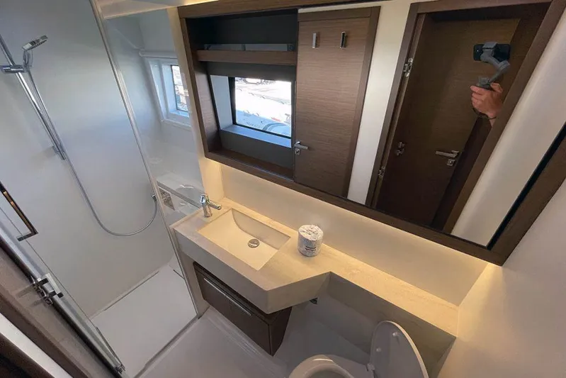 Kowi Kai Yacht Photos Pics Modern bathroom in 2020 Lagoon 50 yacht with shower, sink, and mirror.