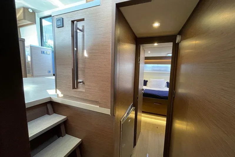 Kowi Kai Yacht Photos Pics Interior of 2020 Lagoon 50 yacht, featuring a hallway leading to a cozy bedroom.