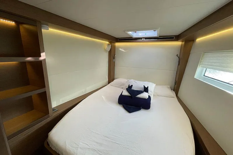 Kowi Kai Yacht Photos Pics Luxurious cabin interior of 2020 Lagoon 50 yacht with cozy bed and modern lighting.