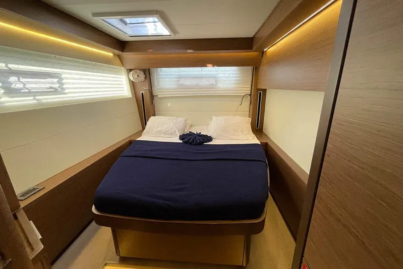 Kowi Kai Yacht Photos Pics Luxurious cabin interior of 2020 Lagoon 50 yacht with cozy bed and modern design.