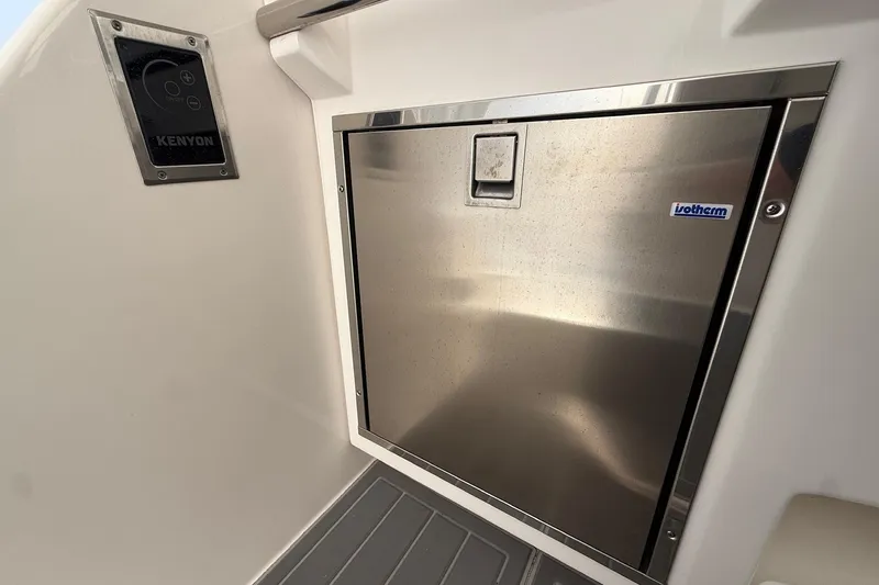  Yacht Photos Pics Stainless steel fridge on 2022 Regal 38 XO boat, featuring Kenyon control panel.
