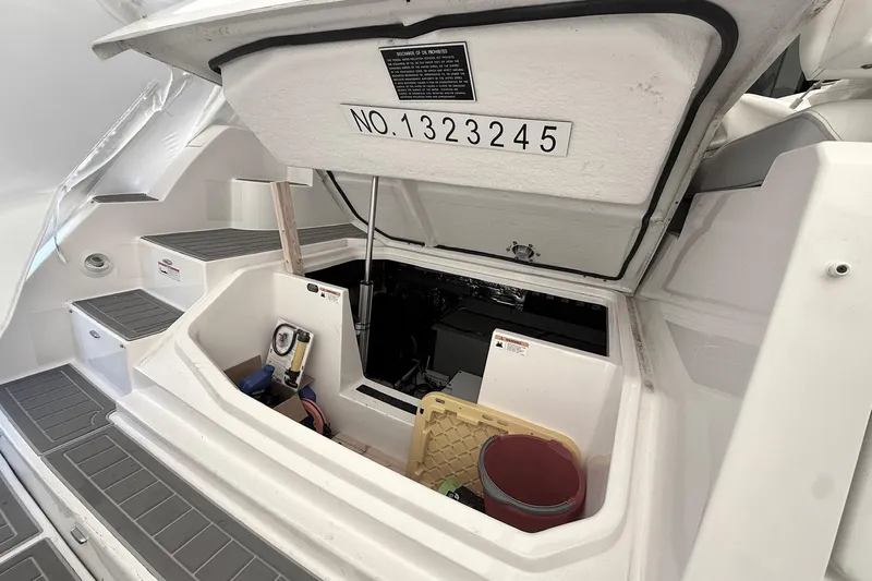  Yacht Photos Pics 2022 Regal 38 XO boat storage compartment with open hatch and equipment inside.