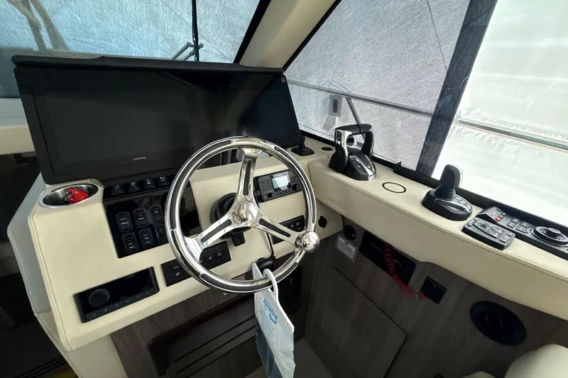  Yacht Photos Pics Interior helm of 2022 Regal 38 XO yacht with steering wheel and controls.